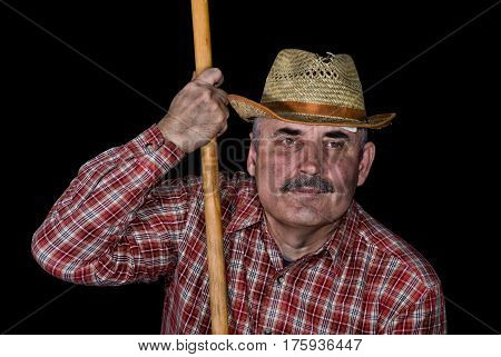 Portrait of a farmer taken in a short break of hard agricultural work.