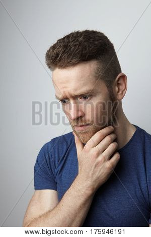 Closeup portrait of sad young man with worried stressed face expression. Obsessive compulsive, anxiety disorders.