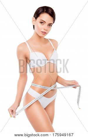 A Portrait Of Young Charming Woman Isolated On White Background Measuring Her Waistline