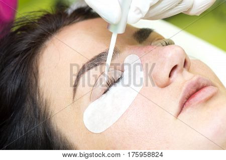 Woman on the procedure for eyelash extensions, eyelashes lamination