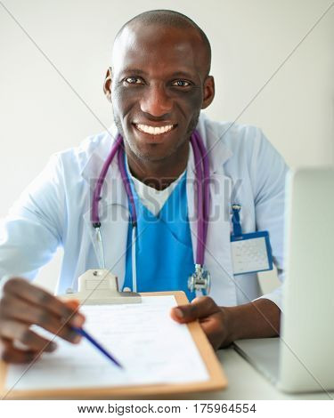 Male doctor sitting at his desk
