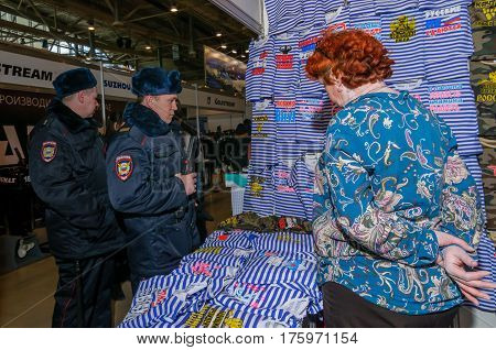 Moscow, Russia - February 25, 2017: Two russian policemen visiting the stand with funny military-patriotic t-shirts and telnyashkas