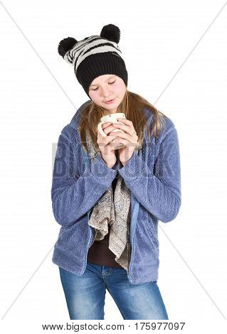 Young girl with jacket and wooly hat holding cup isolated on white background