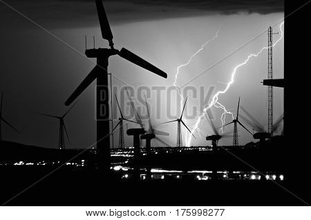 Lightning strike at a wind farm at night
