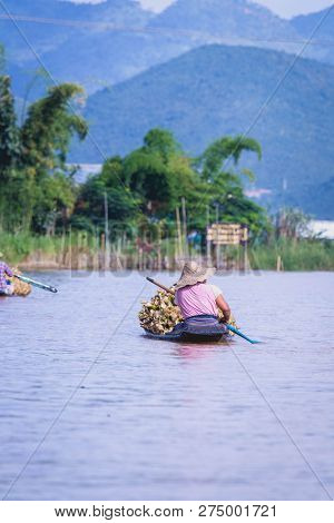 Women Rowing A Dugout Canoe In Inle Lake, Myanmar.