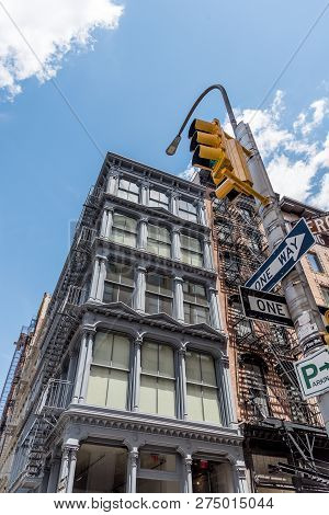 New York City, Usa - June 25, 2018: Low Angle View Of Typical Buildings, Traffic Light And Street Na