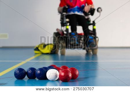 Boccia. A Disabled Sportsman Sitting In A Wheelchair. Close Up Of Little Balls For Playing Boccia. T