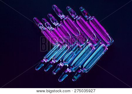 Ampoules On A Black Background In Blue-violet Light