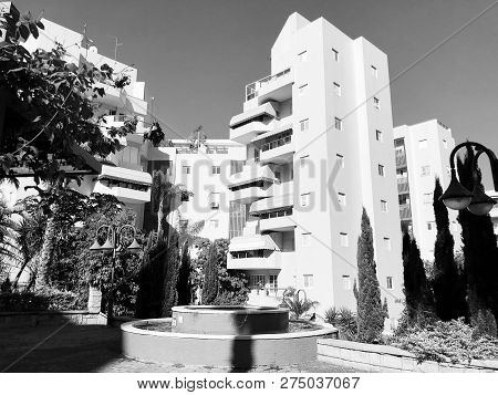 Residential Buildings And Fountain Surrounded With Green Plants In  Rishon Le Zion.