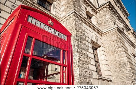 A Traditional Old Red Uk Telephone Box Outside One Of The Many Government Buildings  In Whitehall, L