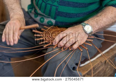A Basket Weaver At Work In The Factory Shop In Camacha On Madeira Island,  Portugal