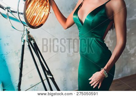 Neckline, Beautiful Large Female Breast, Green Dress, Close-up. Aluminum Cinema Spotlight