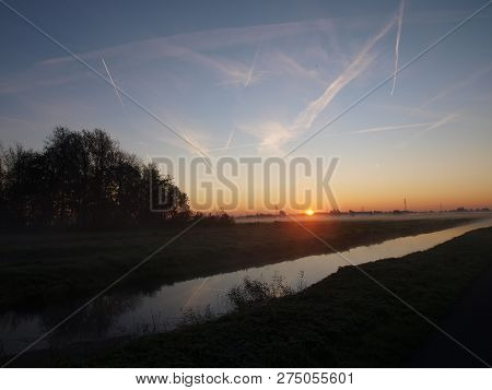 Sunrise With Morning Fog Over The Meadows Of The Polder At Goudarak Close To Gouda In The Netherland