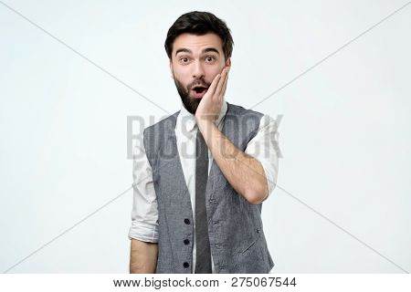 Puzzled Frustrated Male Looks With Bewilderment, Reacts On Sudden Message