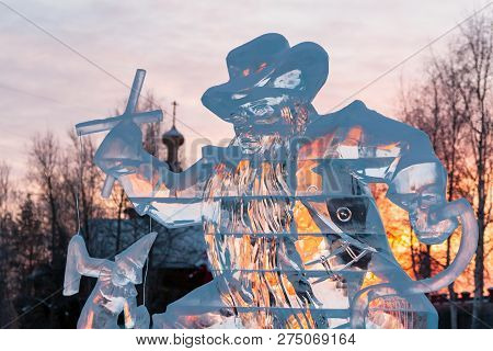 Karabas-barabas. Ice Sculpture-evil Puppeteer Controls A Puppet On The Background Of A Religious Tem