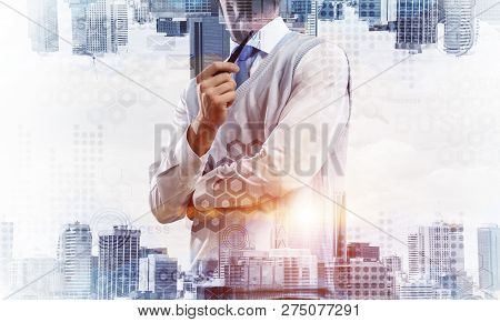 Confident And Young Businessman In Smart-casual Wear Smoking Pipe And Modern Cityscape With Business