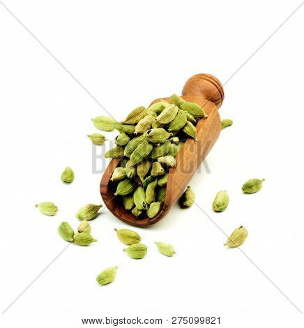 Cardamon Grains In Scoop Isolated On White Background