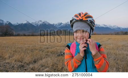One Caucasian Children Walk With Bike In Wheat Field. Little Girl Walking Black Orange Cycle On Back