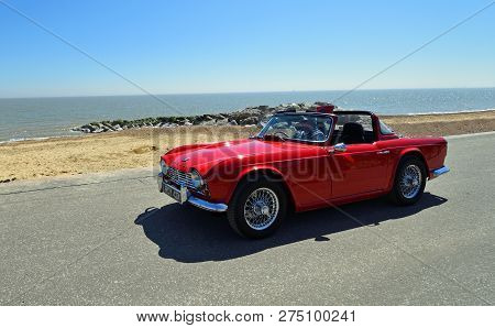 Felixstowe, Suffolk, England -  May 06, 2018: Classic Red Triumph Tr4 Convertible Motor Car Being Dr