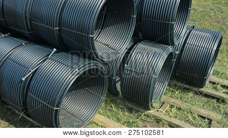 Warehouse Of Finished Plastic Pipes Industrial Outdoors Storage Site. Manufacture Of Plastic Water P