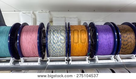 Industrial Warehouse Cable Reels, Coils With Wound Wire Fiber Optics. Fragment Inside Modern Factory