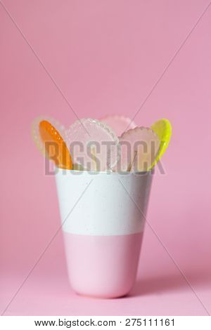 Multi-colored Lollipops On A Pink Background With Decoration