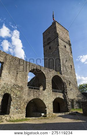 Ruins Of Castle Koenigstein (konigstein) . Wall With Empty Windows And Tower Against The Blue Cloudy