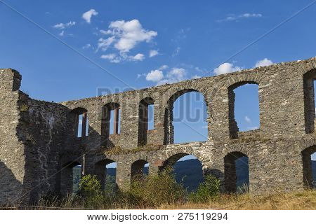 Ruins Of Castle Koenigstein (konigstein) . Wall With Empty Windows Against The Blue Cloudy Sky. Anci