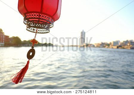 A Beautiful Red Chinese Lantern Hanging Outside The Travelling Ship With Blurred Riverscape In Bangk