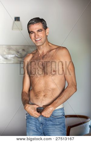 Portrait of handsome shirtless middle aged man smiling
