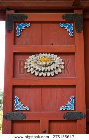 Nagasaki, Japan - October 24, 2018: Crysanthemum flower and lucky bat decorations woodcarved on a door at Sofukuji Temple 