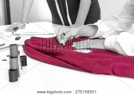 Professional Fashion Designer Working And Drawing Sketches On The Table With Computer Tablet And Col