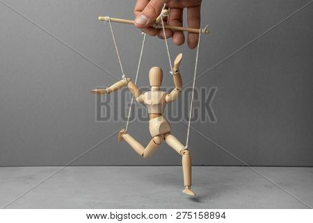 The Puppeteer Holds The Doll By The Rope. The Doll Does Not Obey The Puppeteer