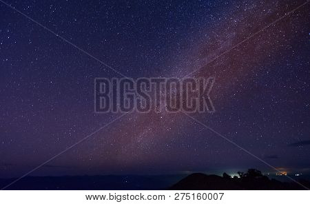 Night Landscape With Colorful Milky Way And Yellow Light At Mountains At Doi Mon Jong, Chiang Mai, T