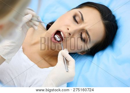 Young Female Patient Visiting Dentist Office.beautiful Woman With Healthy Straight White Teeth Sitti