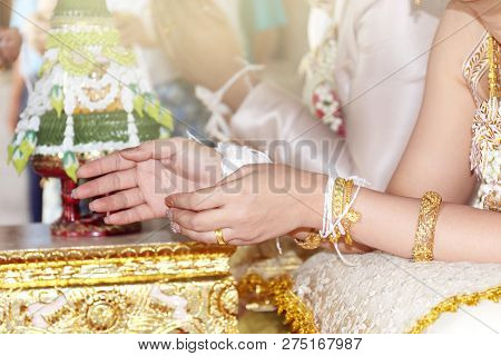 Traditional Thai Wedding, The Bride's Hands Are Tied With Thread From The Older Culture Of Tradition