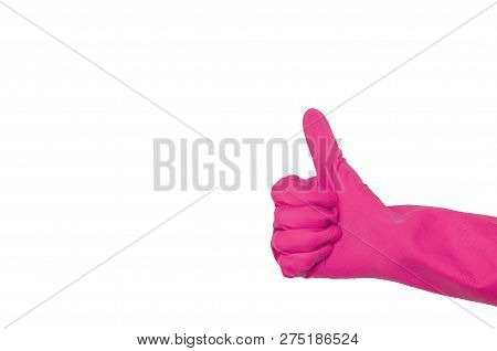 Pink Glove For Cleaning On A Female Hand Shows Thumb Up. The Concept Of Cleanliness.