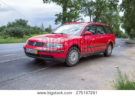 Red Wolksvagen Passat B5 To Street, Trees An Way. Travel Photo 2012.