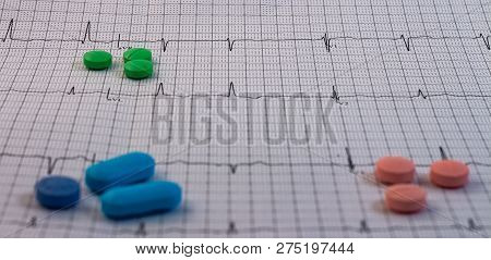 Pills And Medicines Of Green Color On An Electrocardiogram. Drugs For Human Consumption.