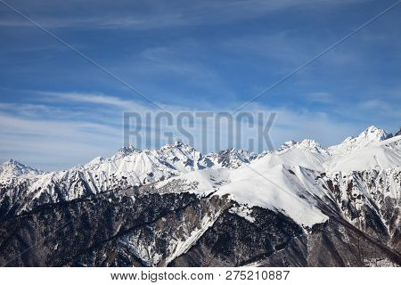 Sunlight Snowy Mountains And Blue Sky With Clouds In Sunny Day. Caucasus Mountains At Winter. Georgi