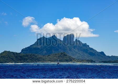 Bora-bora Island With Turquoise Surf And Thatched Bungalows On The Beach In The Leeward Group Of The