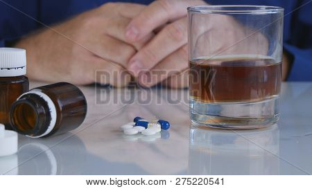 Addicted Man With Vicious Behavior Take Pills With Alcohol And Smoke A Cigarette