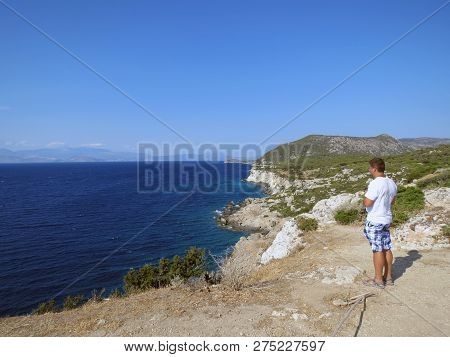 Europe, Greece, Acre Ireo, Man Enjoys The Beauty
Of The Gulf Of Corinth