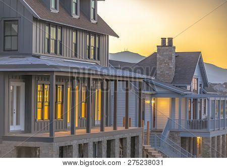 Glowing Homes With Mountain And Sky Background