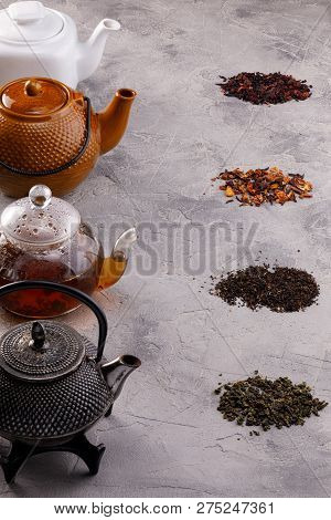 Still Life For A Tea Card. Different Varieties Of Tea Leaves And Teapots. The Concept Of Tea Drinkin