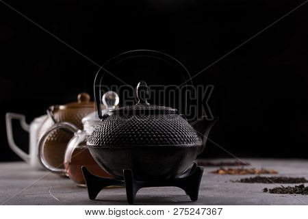 Still Life For A Tea Card. Different Varieties Of Tea Leaves And Teapots. The Concept Of Tea Drinkin