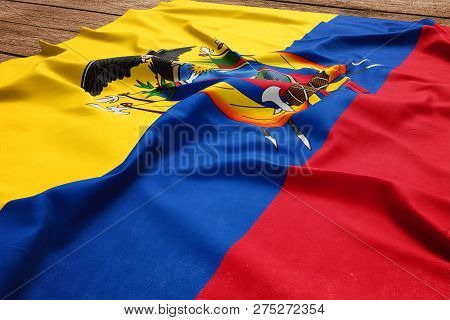 Flag Of Ecuador On A Wooden Desk Background. Silk Ecuadorean Flag Top View.