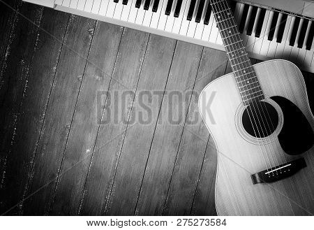 Musical Instrument - Sloseup Midi Piano 61 Key Keyboard And Acoustic Guitar On A Wooden Background M