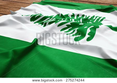 Flag Of Norfolk Island On A Wooden Desk Background. Silk Flag Top View.