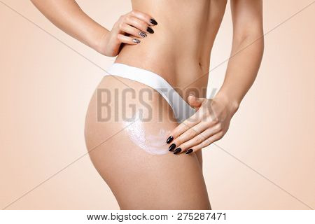 Shot Of Fit Womans Body Applies Body Cream, Wears White Panties, Uses Lotion Against Cellulite, Has 